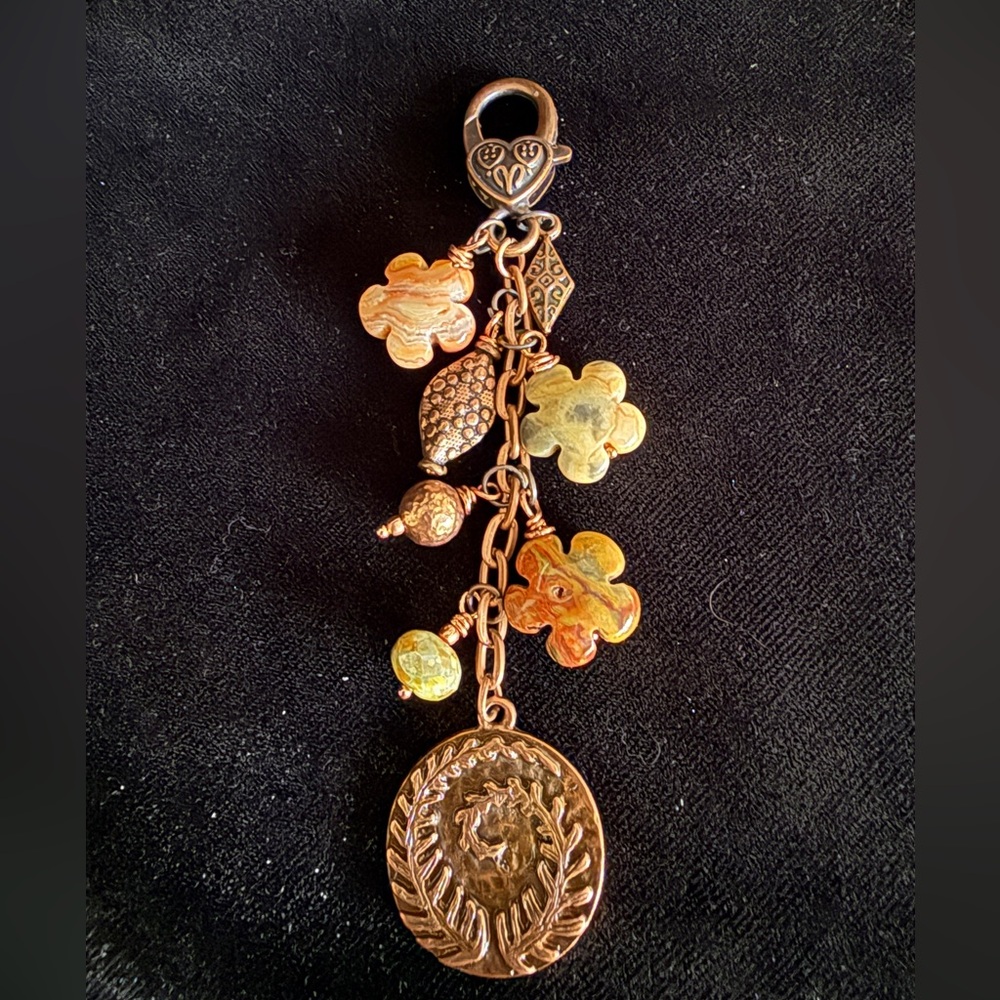 Elegant copper colored bag charm hangs 4 inches